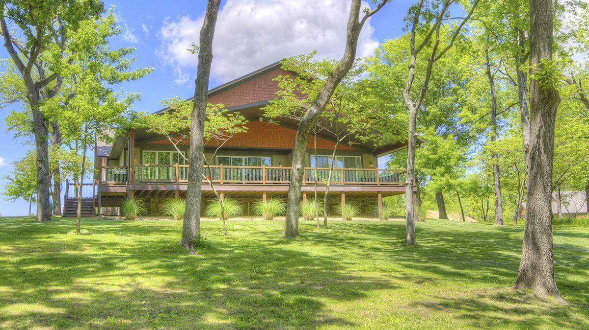 Our custom homes are nestled in-between tall mature trees and back up to the shores of Grand Lake! This home enjoys the Lakeview off the expansive deck and the sounds of running water from the waterfall feature along the developments walking trails.