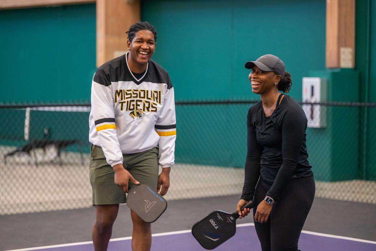 Jeremiah Gant and Imani Simmons shared a laugh during a pause in play at the meeting of the Black Pickleball Club at SW19 at the Stadium, on Sunday, Feb. 22, in Kansas City. 