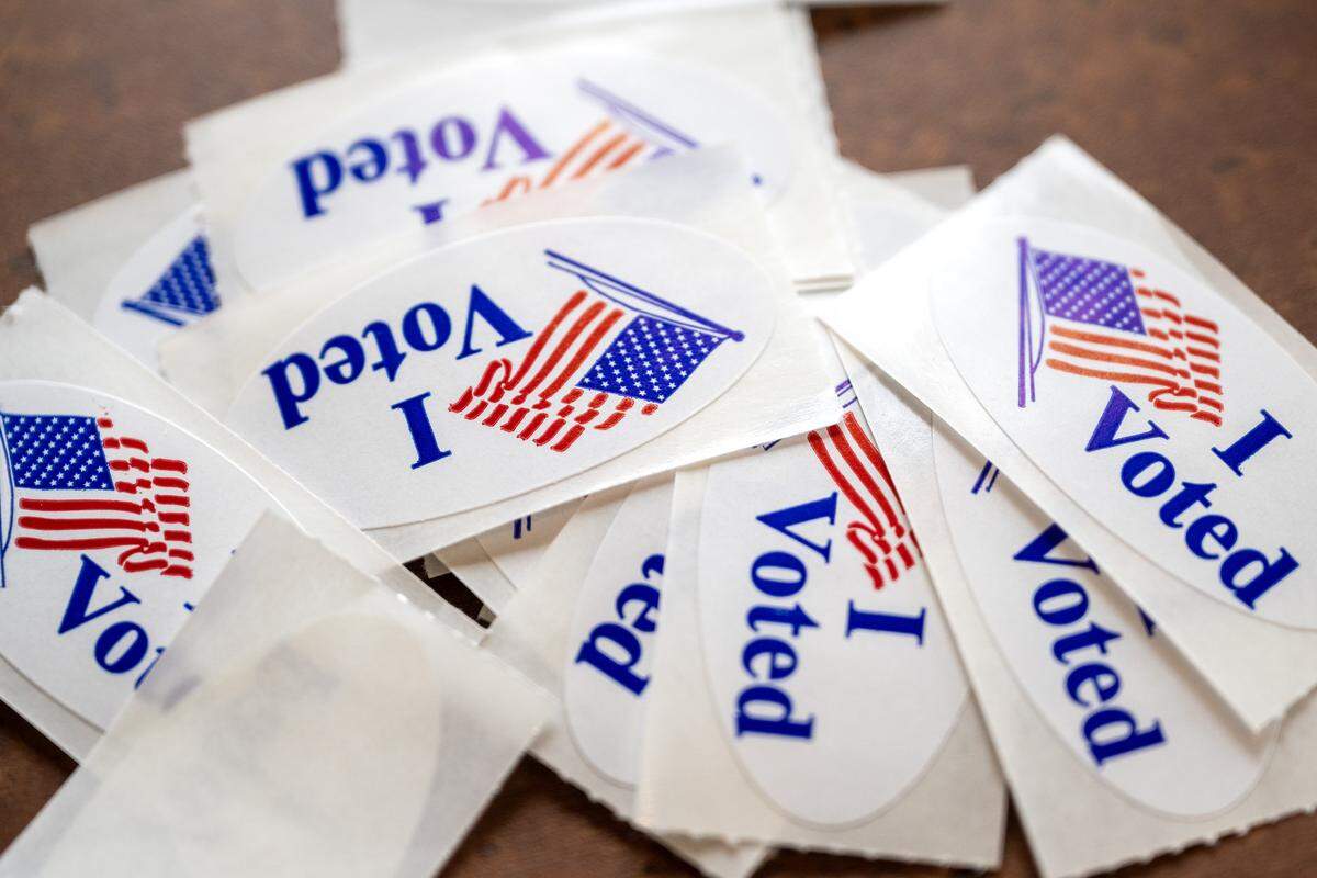 “I Voted” stickers are placed on a table near the entrance at Thousand Oaks Oasis Pool and Clubhouse during Election Day on Tuesday, April 7, 2026, in Parkville