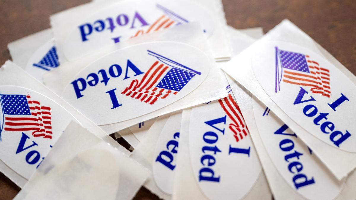 “I Voted” stickers are placed on a table near the entrance at Thousand Oaks Oasis Pool and Clubhouse during Election Day on Tuesday, April 7, 2026, in Parkville