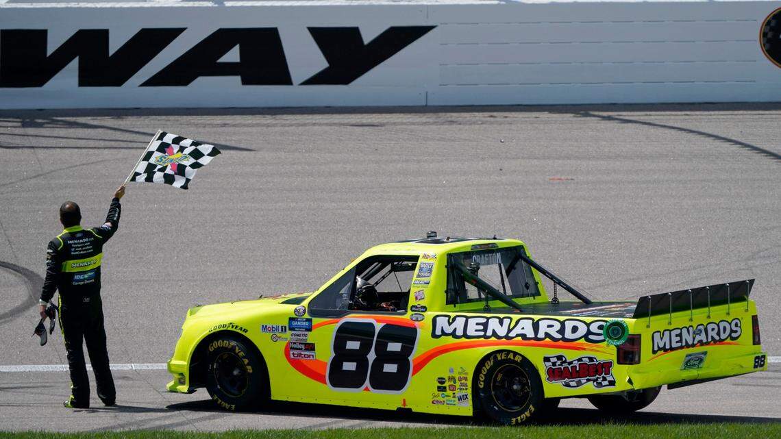Matt Crafton waved the checkered flag after winning a NASCAR Truck Series auto race at Kansas Speedway on Saturday, July 25, 2020.