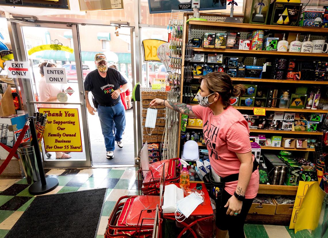 Marci Boone hands out masks to each customer wanting one at Dick’s 5 & 10. Branson leaders debated a proposed mask mandate for more than 8 hours Thursday.