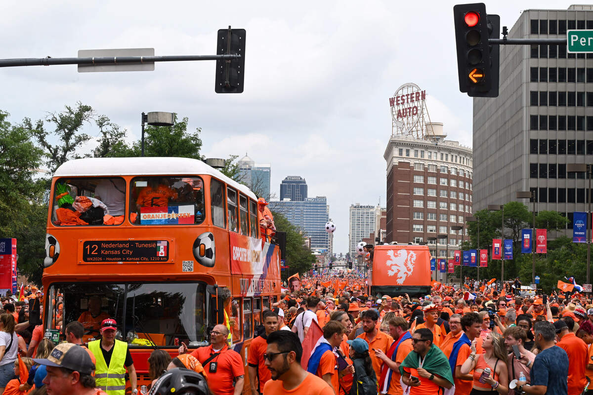Dutch fans and their iconic ‘Oranje bus’ pass by the Western Auto building as part of the Netherlands Orange Walk from Kansas City’s Power & Light District to FIFA Fan Fest on June 25, 2026.