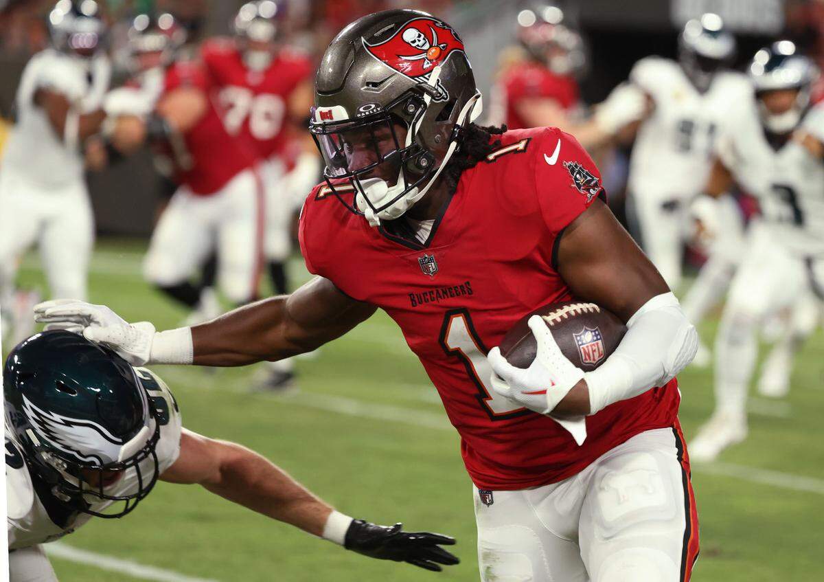Tampa Bay Buccaneers running back Rachaad White (1) stiffarms Philadelphia Eagles safety Reed Blankenship (32) during the first half at Raymond James Stadium on Sept. 25, 2023.