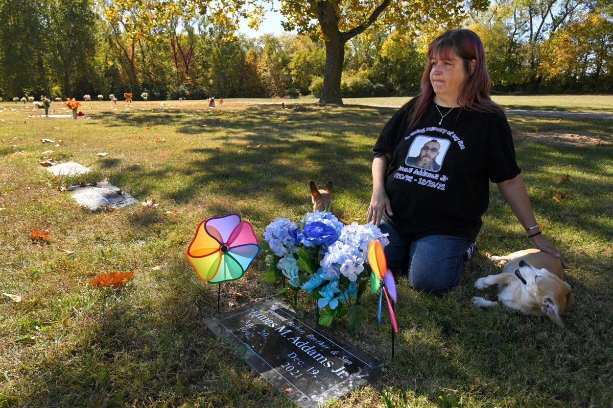 With her son’s dogs in tow, Katrina Smith visits the grave of James Michael Addams Jr., 29, on Friday, Oct. 20, 2023, at Oak Ridge Memory Gardens in Independence, Missouri. Addams and his fiancee died from fentanyl poisoning in 2021 after taking a pill they thought was a “molly,” Smith said. She said police told her that her son’s toxicology report showed “he had enough fentanyl in his system to kill 10 people.”