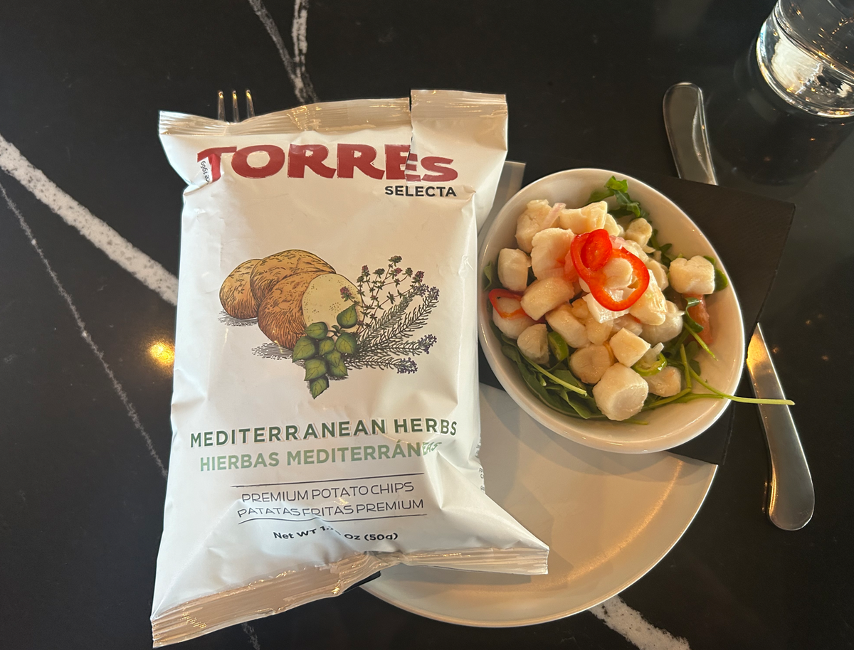 The bay scallop ceviche, served with Spanish potato chips.