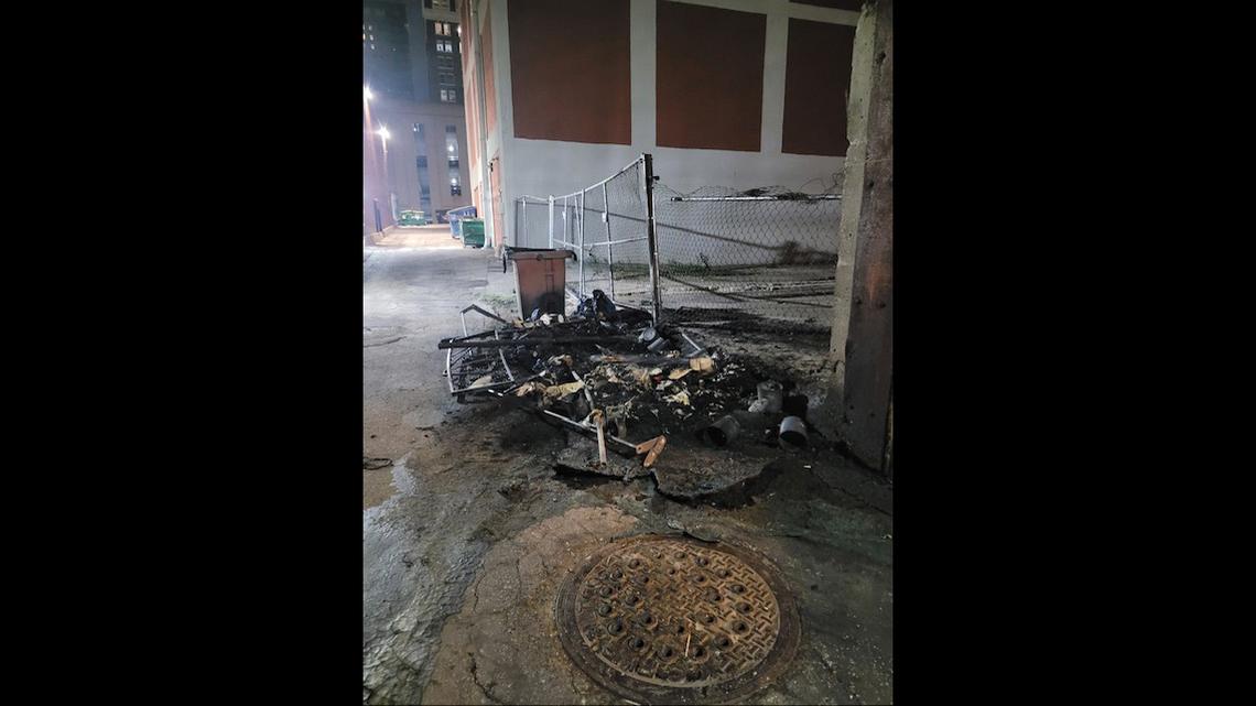Remains of a dumpster set on fire in downtown Kansas City. Neighbors to the Morning Glory Ministries breakfast insist vandalism, harassment and other incidents have increased since the program relocated to 9th and Baltimore last year.