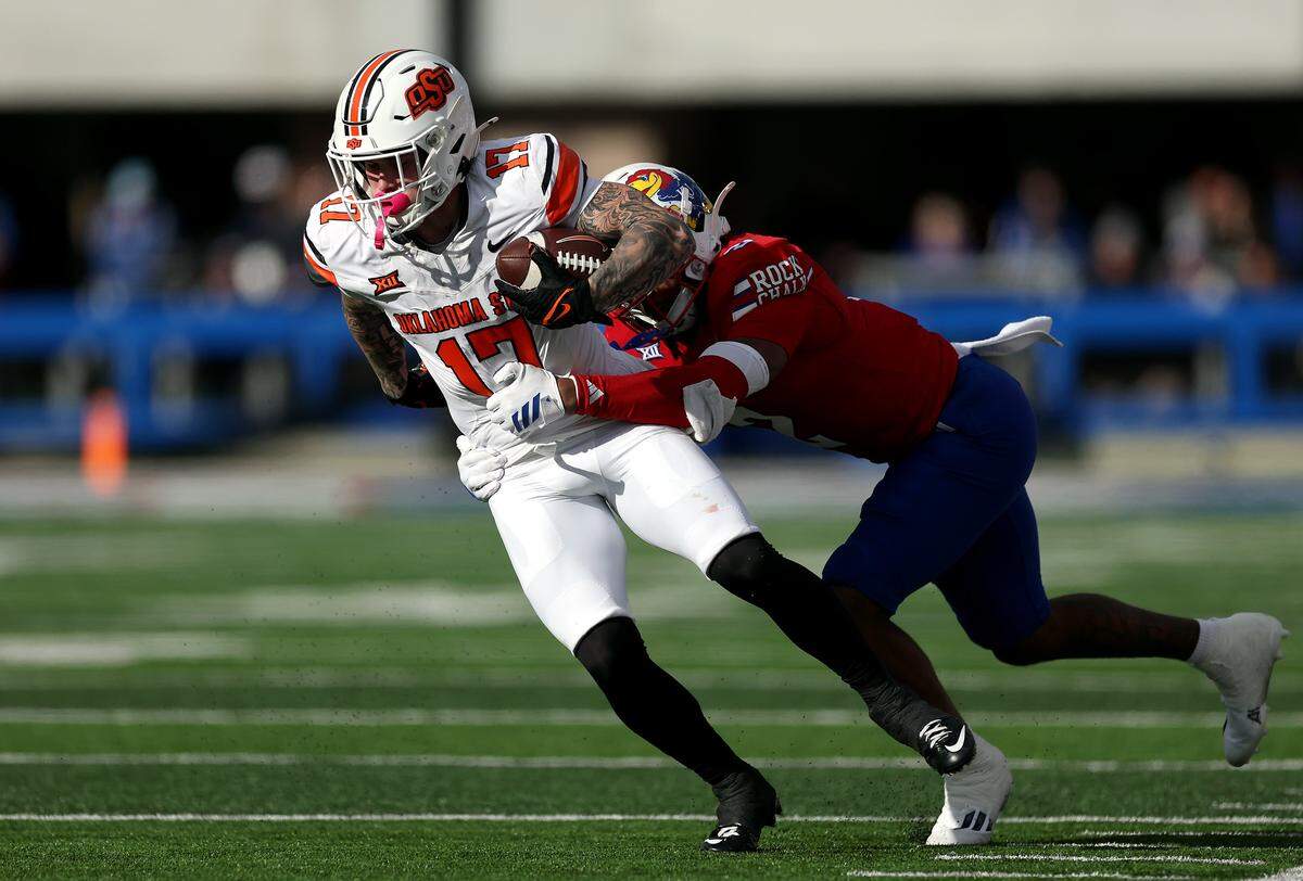 Kansas Jayhawks safety Lyrik Rawls tackles Oklahoma State Cowboys receiver Gavin Freeman during a Saturday, Nov. 1, 2025 college football game at David Booth Kansas Memorial Stadium in Lawrence, Kansas.