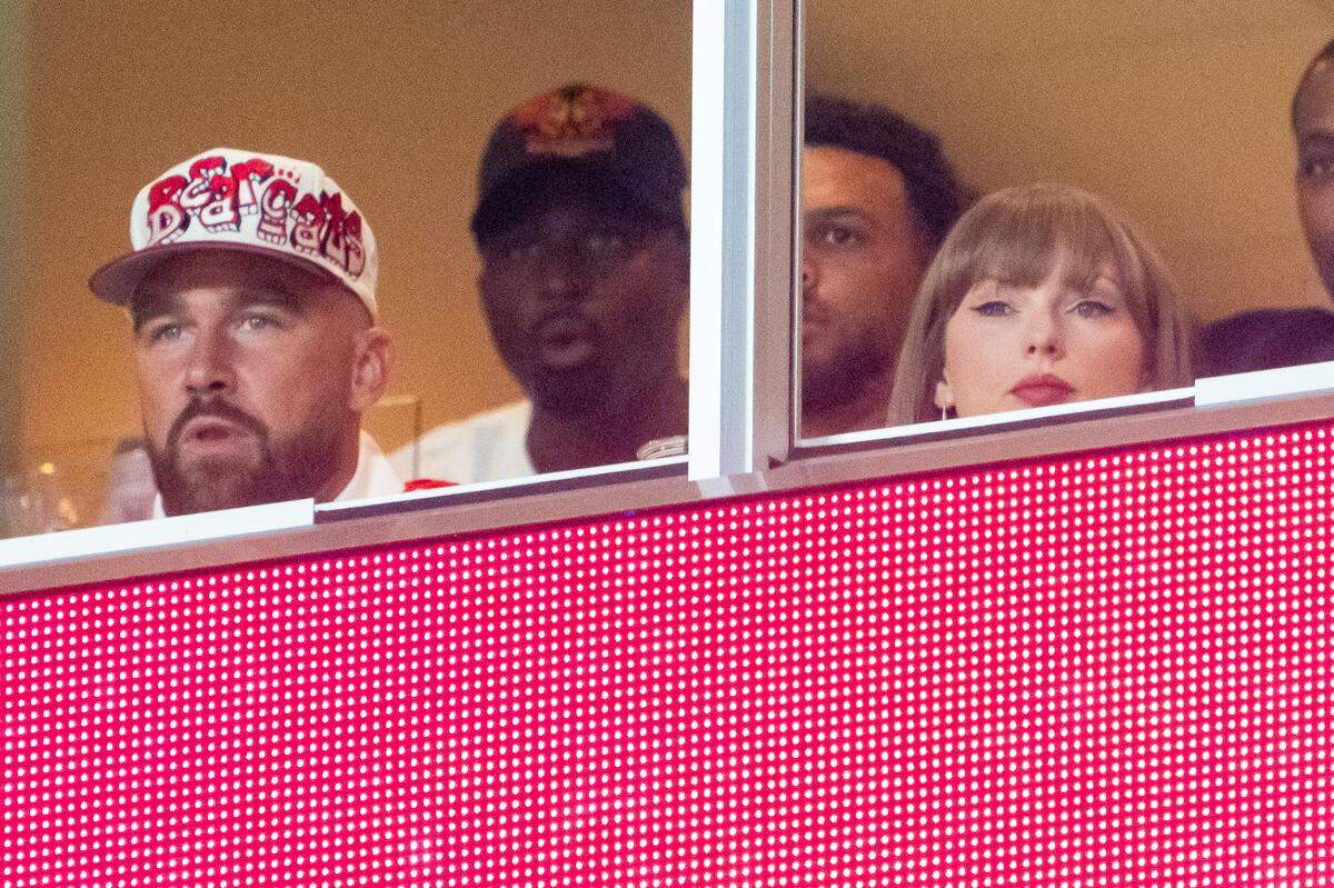 Travis Kelce, Taylor Swift and Jason Kelce watch during the second quarter between the Cincinnati Bearcats and the Nebraska Cornhuskers at GEHA Field at Arrowhead Stadium.