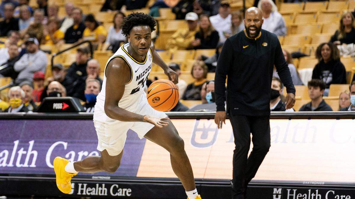 Missouri’s Kobe Brown, left, chases a loose ball in front of coach Cuonzo Martin during the second half of an NCAA college basketball game against Kansas City Monday, Nov. 15, 2021, in Columbia, Mo. Kansas City won 80-66. (AP Photo/L.G. Patterson)