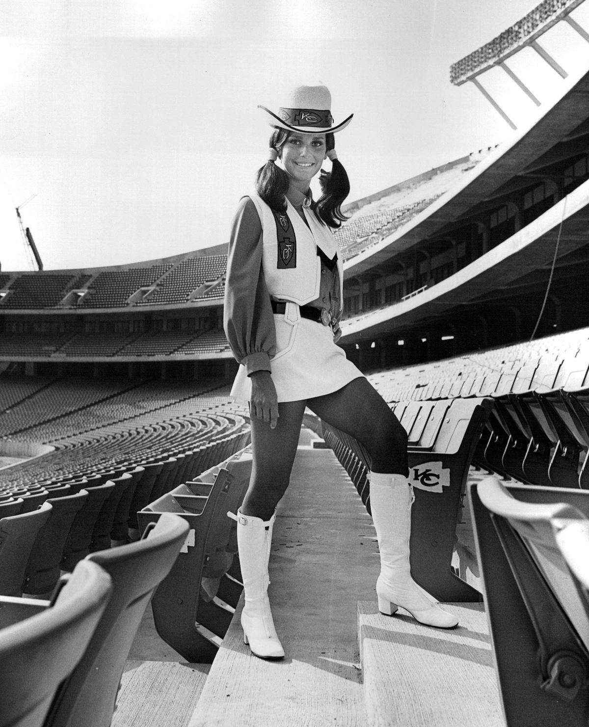 Sydna Bunton models the uniforms that will be worn by the Arrowettes at Arrowhead Stadium, the new home of the Kansas City Chiefs. The Arrowettes were not cheerleaders but were the official hostesses and ushers at the newly opened stadium in 1972.