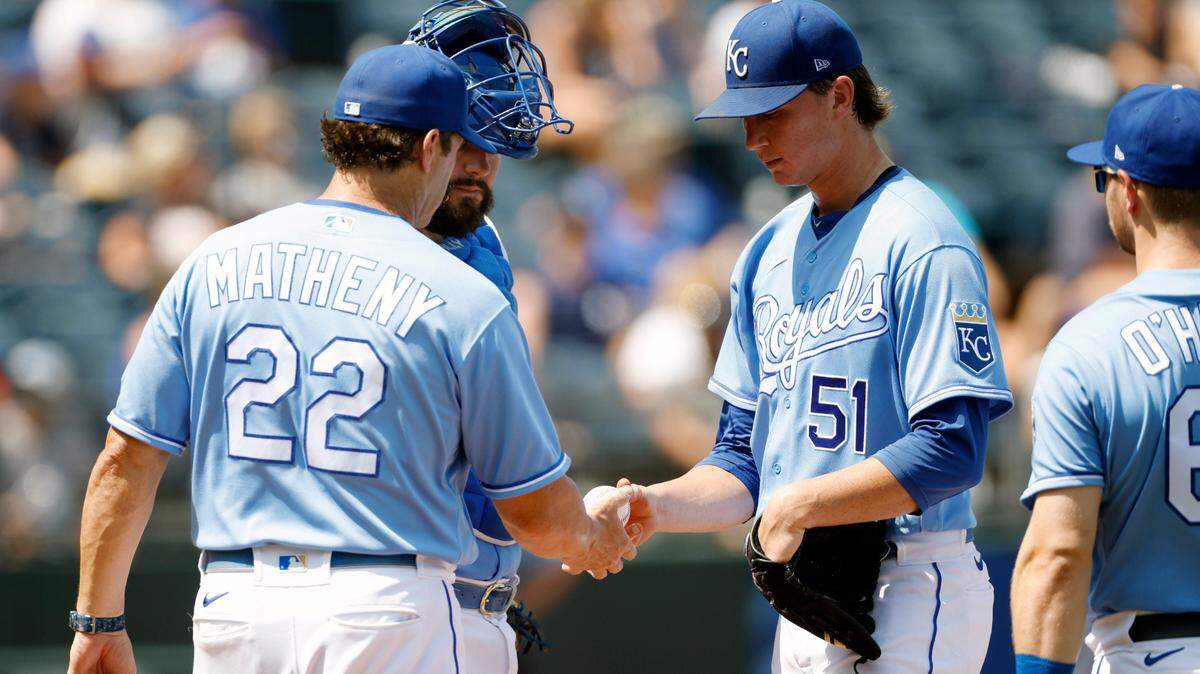 Kansas City Royals manager Mike Matheny (22) takes the ball from Kansas City Royals pitcher Brady Singer (51) as he is removed in the fourth inning of a baseball game against the New York Yankees at Kauffman Stadium in Kansas City, Mo., Wednesday, Aug. 11, 2021. (AP Photo/Colin E. Braley)