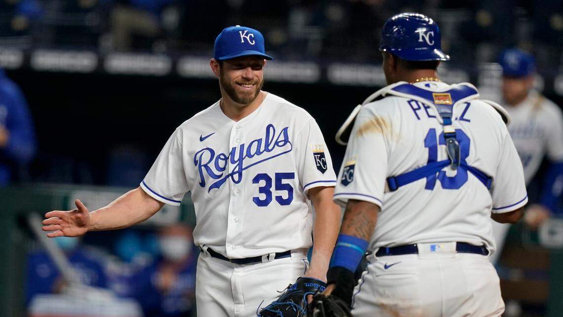 Kansas City Royals relief pitcher Greg Holland (35) celebrates with catcher Salvador Perez (13) following a baseball game against the Los Angeles Angels at Kauffman Stadium in Kansas City, Mo., Tuesday, April 13, 2021. The Royals defeated the Angels 3-2. (AP Photo/Orlin Wagner)