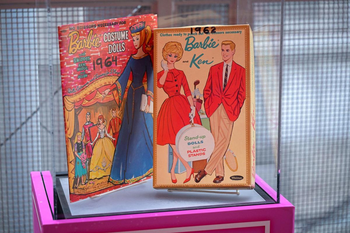Two-dimensional Barbie costume dolls from 1964 and 1962 are on display near Union Station’s Regnier Extreme Screen Theatre, where the Barbie movie will open on Friday.