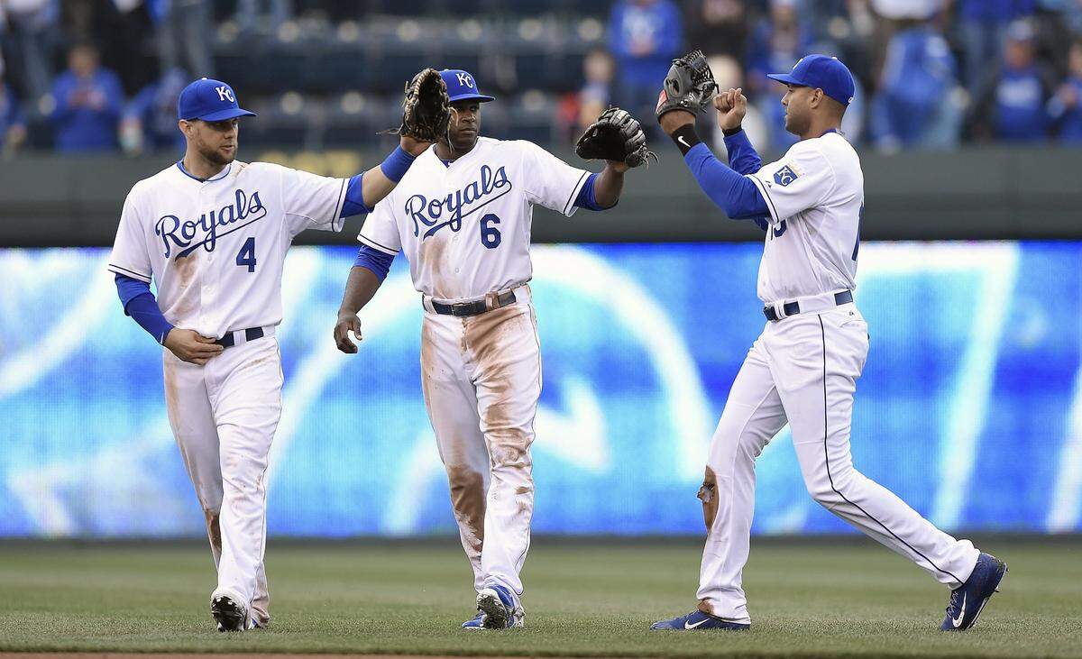Kansas City Royals left fielder Alex Gordon (4), center fielder Lorenzo Cain (6) and right fielder Alex Rios (15) celebrate the teams 10-1 win over the Chicago White Sox during the home opener on April 6, 2015 at Kauffman Stadium in Kansas City, Mo.