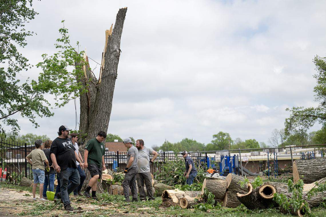 Volunteers helped a resident with cleanup of a large, fallen tree on a residential lot in the 600 block of East Bodine St., in Clinton Missouri, on Thursday, April 16, 2026, one day after a tornado touched down in Henry County.  