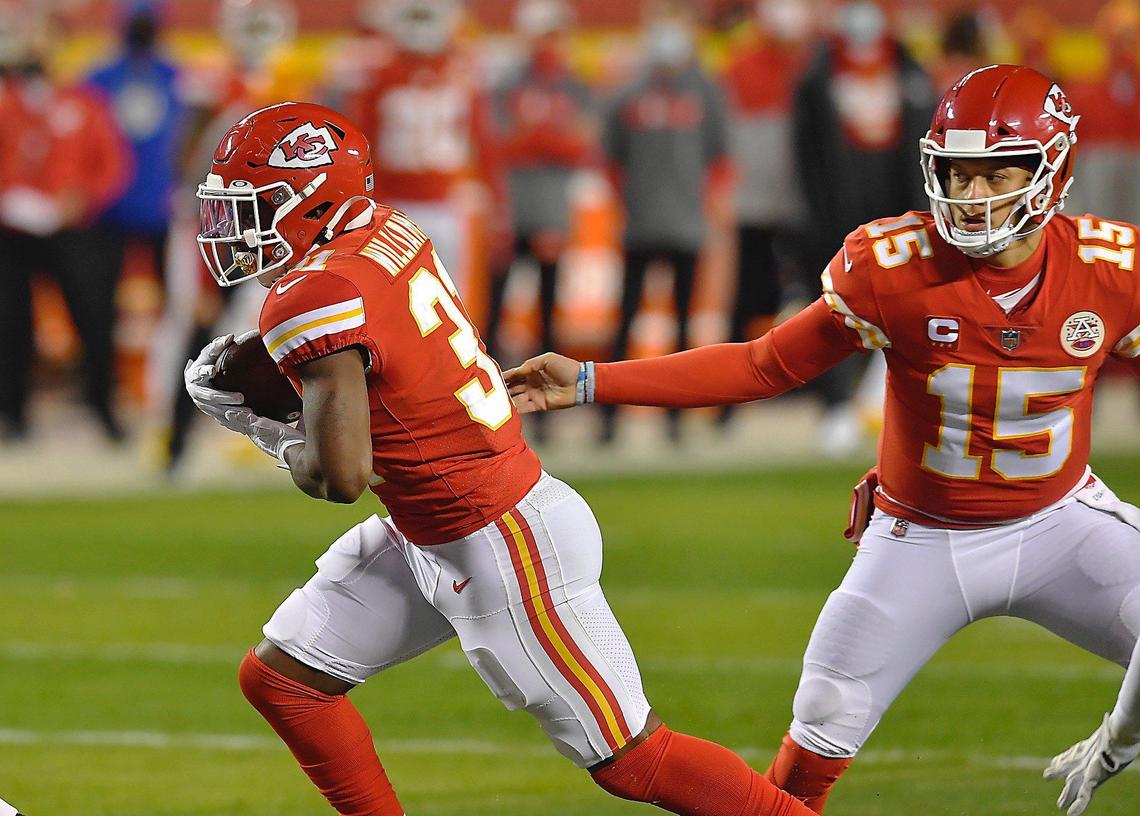 Kansas City Chiefs quarterback Patrick Mahomes hands ff the football to running back Darrel Williams who took it in for a touchdown in the second quarter Sunday, January 24, 2021, during the AFC Championship Game at Arrowhead Stadium in Kansas City, Missouri.