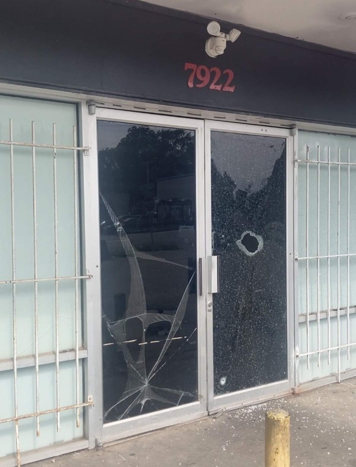 A glass door shattered by bullets following a shooting Saturday morning, June 6, 2026, at Big Mama’s House Party, an unlicensed club at 79th Terrace and Troost Avenue.
