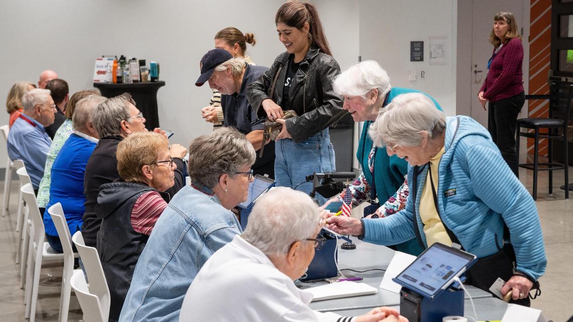 Election workers help sign in voters on Election Day at the Johnson County Arts and Heritage Center in Overland Park on Tuesday, Nov. 5.