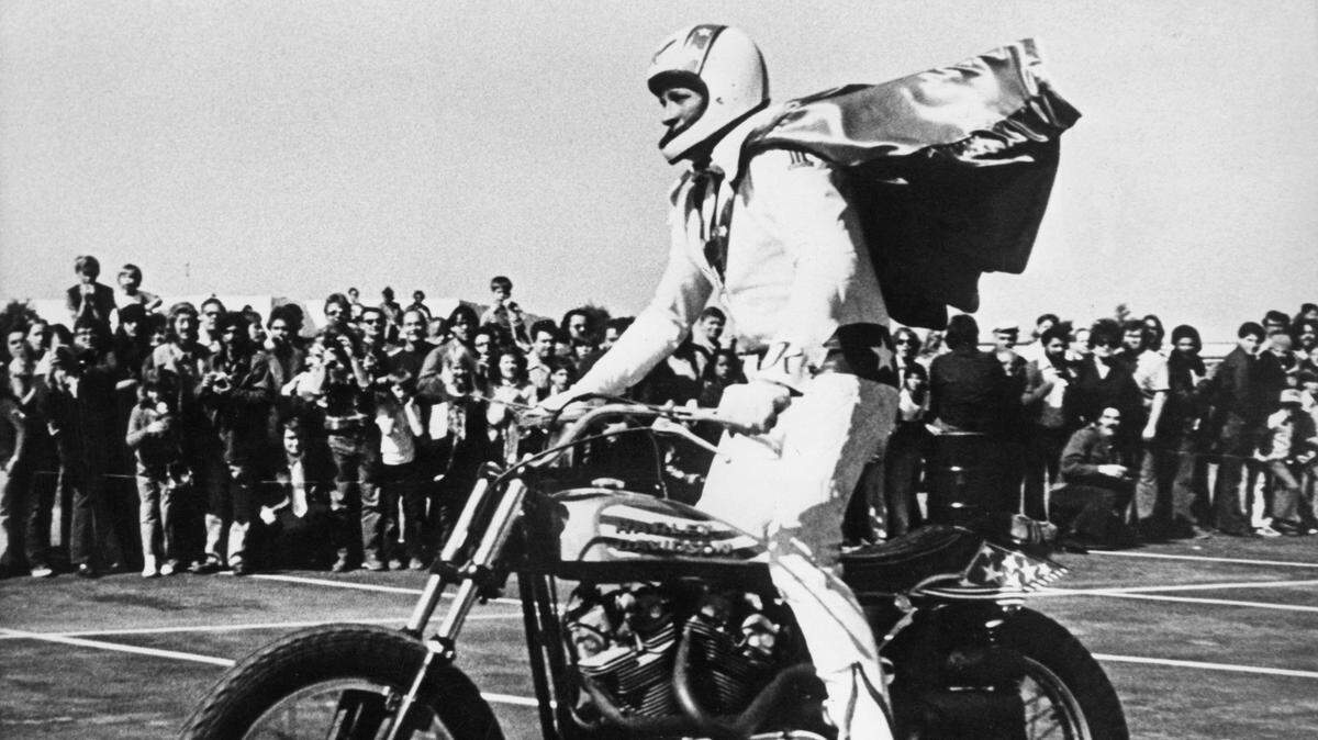 Iconic American daredevil and stunt performer Evel Knievel on a Harley Davidson motorcycle, circa 1975.