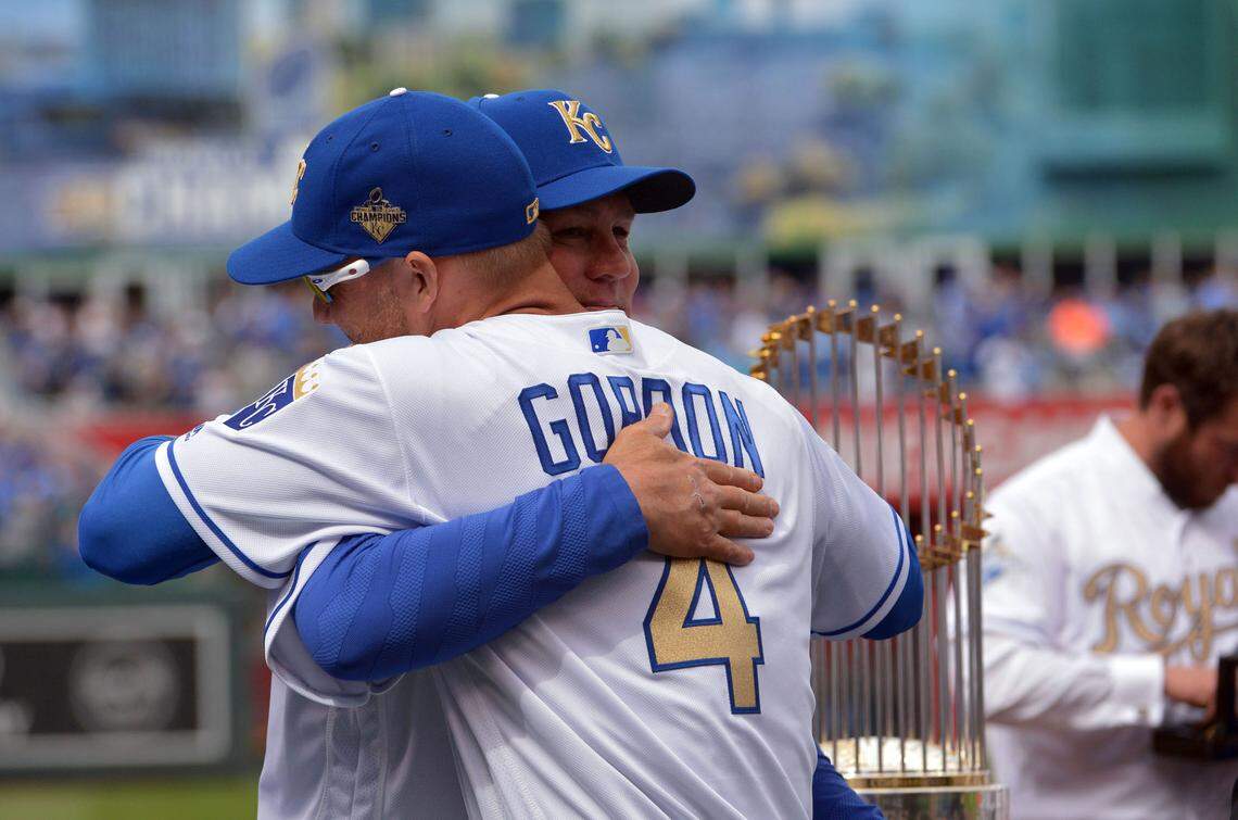 Kansas City Royals left fielder Alex Gordon (4) is embraced by manager Ned Yost (3) as he receives his World Series ring before the game against the New York Mets at Kauffman Stadium on April 5, 2016.