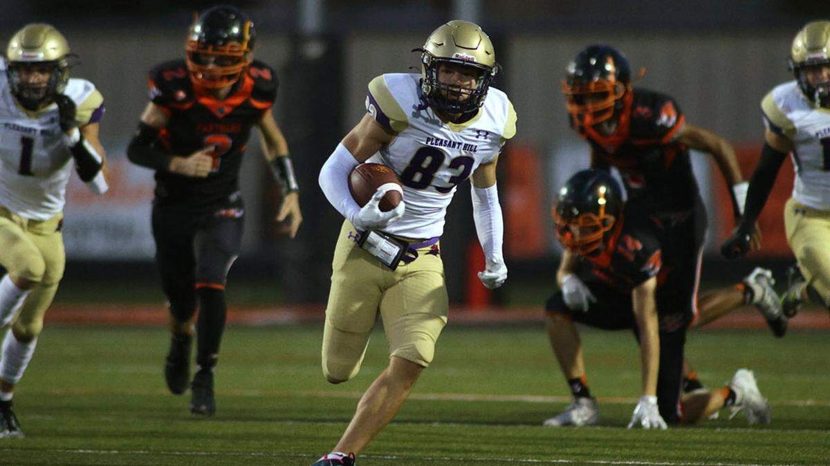 Pleasant Hill senior Tyler Wise eludes Oak Grove’s defense on a play during Friday night’s high school football game. Pleasant Hill rolled past Oak Grove 61-44.