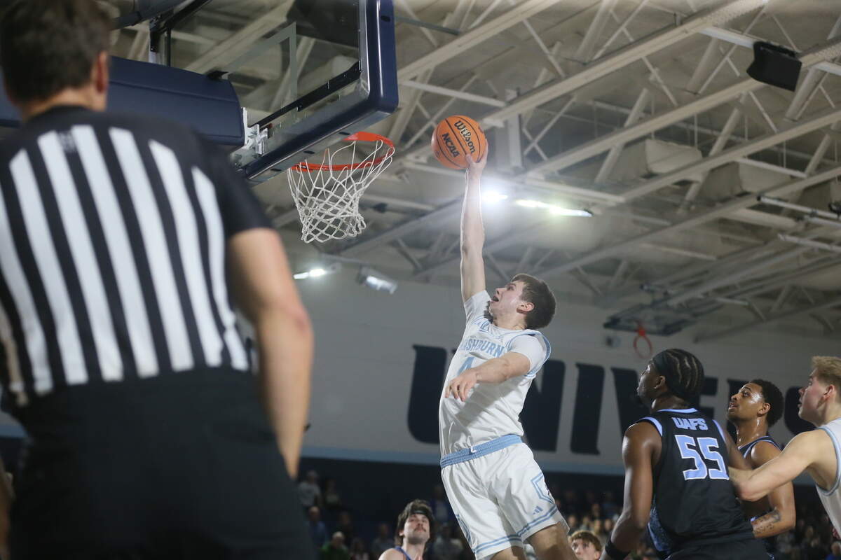 Sophomore forward Dillon Claussen soars for a one-handed dunk against Arkansas-Fort Smith on Feb. 12. Claussen spent his freshman year coming off the bench before emerging as Washburn’s leading scorer from inside and outside the paint.