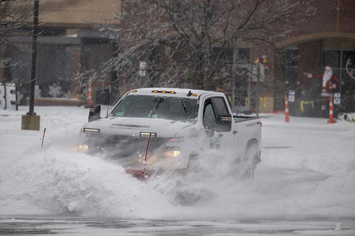 A crew member from Green Lawn, a landscape company in Shawnee, plowed snow from a shopping center parking lot at 10064 Woodland Rd., in western Lenexa on Sunday, Jan. 5, 2025.