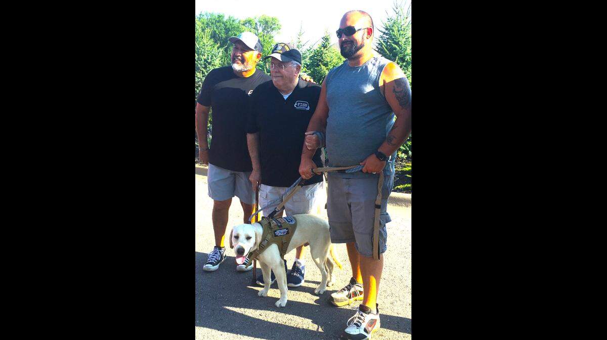 On the far right, Jeff Mason, a U.S. Marine from Wichita, was presented a service dog during the opening ceremony of the Combat Golf Tournament, sponsored by Friends in Service of Heroes, in Basehor. From the left are Paul Chapa, founder of FISH, and Rick “Doc” Pustka, a Marine and Vietnam veteran.
