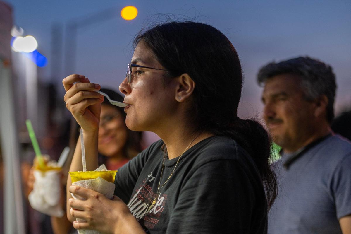 Esli Franco savors a raspado bought from a vendor at 18th Street and Central Avenue. The intersection has emerged this summer as a kind of hub for street food in Kansas City, Kansas.