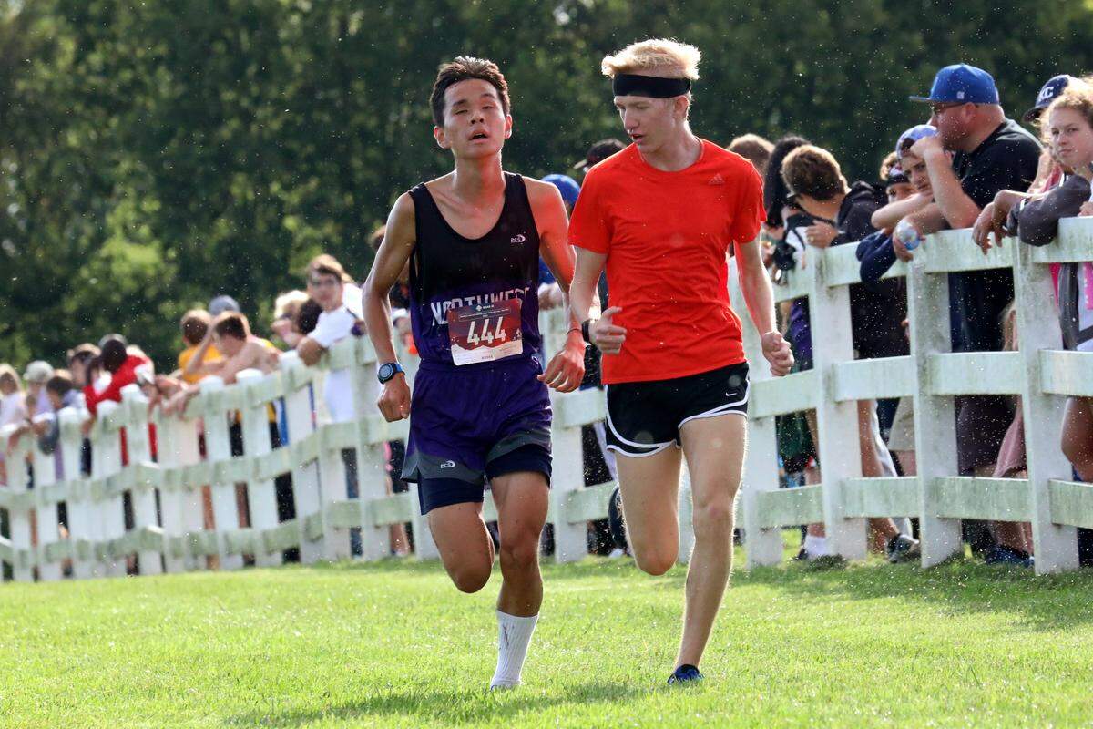 Liam Thurlby, left, guided by Shane Friedrichsen, nears the finish line of a 5K race at the Ray-Pec Invitational in mid-September.