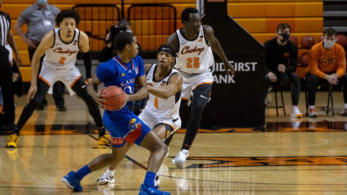 Oklahoma State’s Avery Anderson III (0) guards Kansas’ Bryce Thompson (24) during the second half of the NCAA college basketball game in Stillwater, Okla., Tuesday, Jan. 12, 2021. (AP Photo/Mitch Alcala)