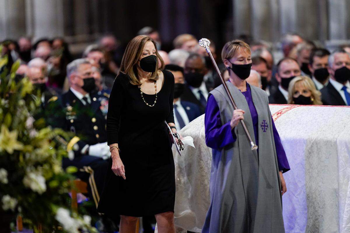Robin Dole, daughter of former Sen. Bob Dole of Kansas, walks by her father’s casket during his funeral service at the Washington National Cathedral, Friday, Dec. 10, 2021, in Washington. (AP Photo/Evan Vucci)