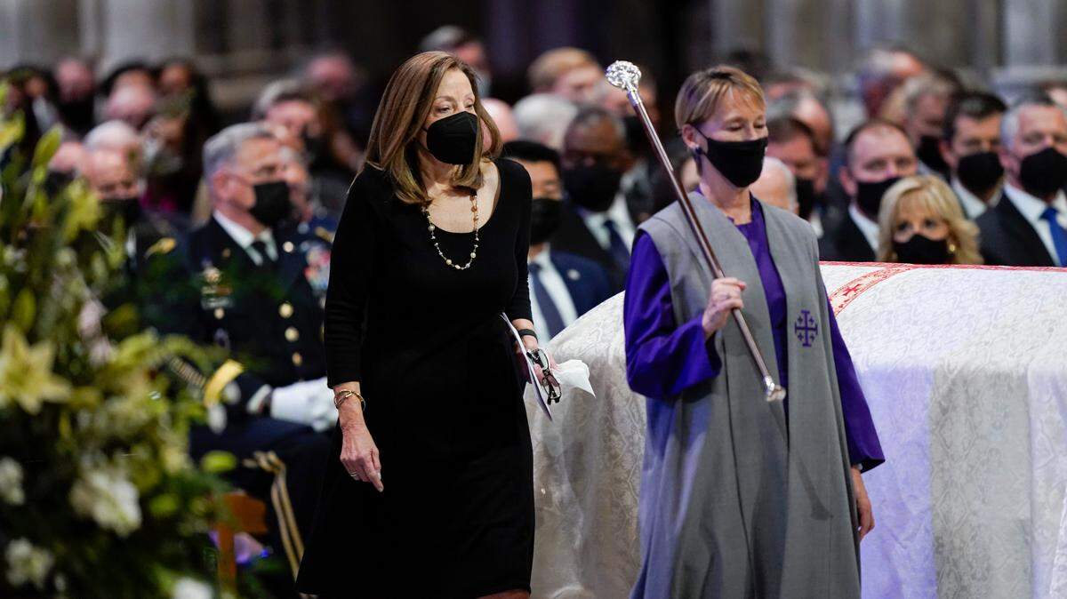 Robin Dole, daughter of former Sen. Bob Dole of Kansas, walks by her father’s casket during his funeral service at the Washington National Cathedral, Dec. 10, 2021, in Washington.
