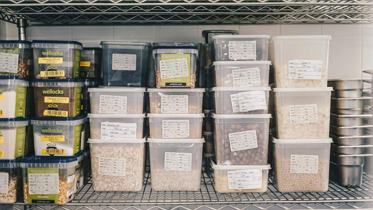 Containers of food are stacked in a restaurant kitchen in this stock photo. Some Kansas City-area restaurants received low scores on their health inspections.