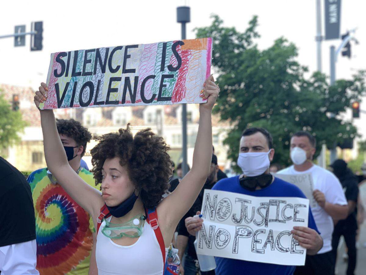 Protesters began to march down Main Street at about 7 p.m. on Tuesday, June 2, 2020. One protester held the sign “Silence is Violence.”