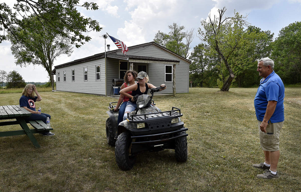 Orin Jackson (right) built Hickory Hills Veterans Lodge to give veterans the opportunity to be outdoors with other veterans and heal. Retired Army medic Chris Wolfenbarger (not pictured) brought his family to the lodge recently and, thanks to Jackson, said he was able to keep a promise he made to his 17-year-old stepdaughter Morgan Sword (driving) about getting on an ATV. Morgan is riding with her sister Madison Wolfenbarger, 13, as his mother-in-law Connie Dukes (left), an Air Force veteran during the Vietnam War, watches.