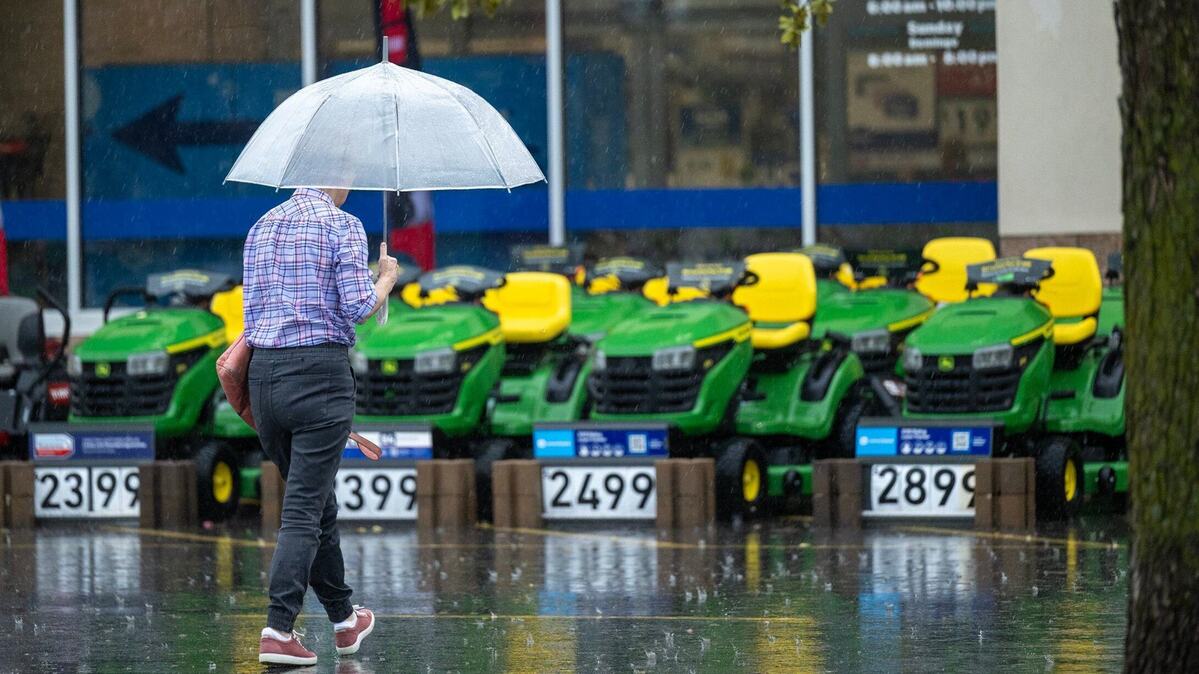 Lawn mowing will be rained out for the next couple days as storms the National Weather Service says storms are expected to pass through the Kansas City area over the next couple days. A shopper, shieled by an umbrella, heads into a home improvement store as heavy rain fell on Thursday in Shawnee.