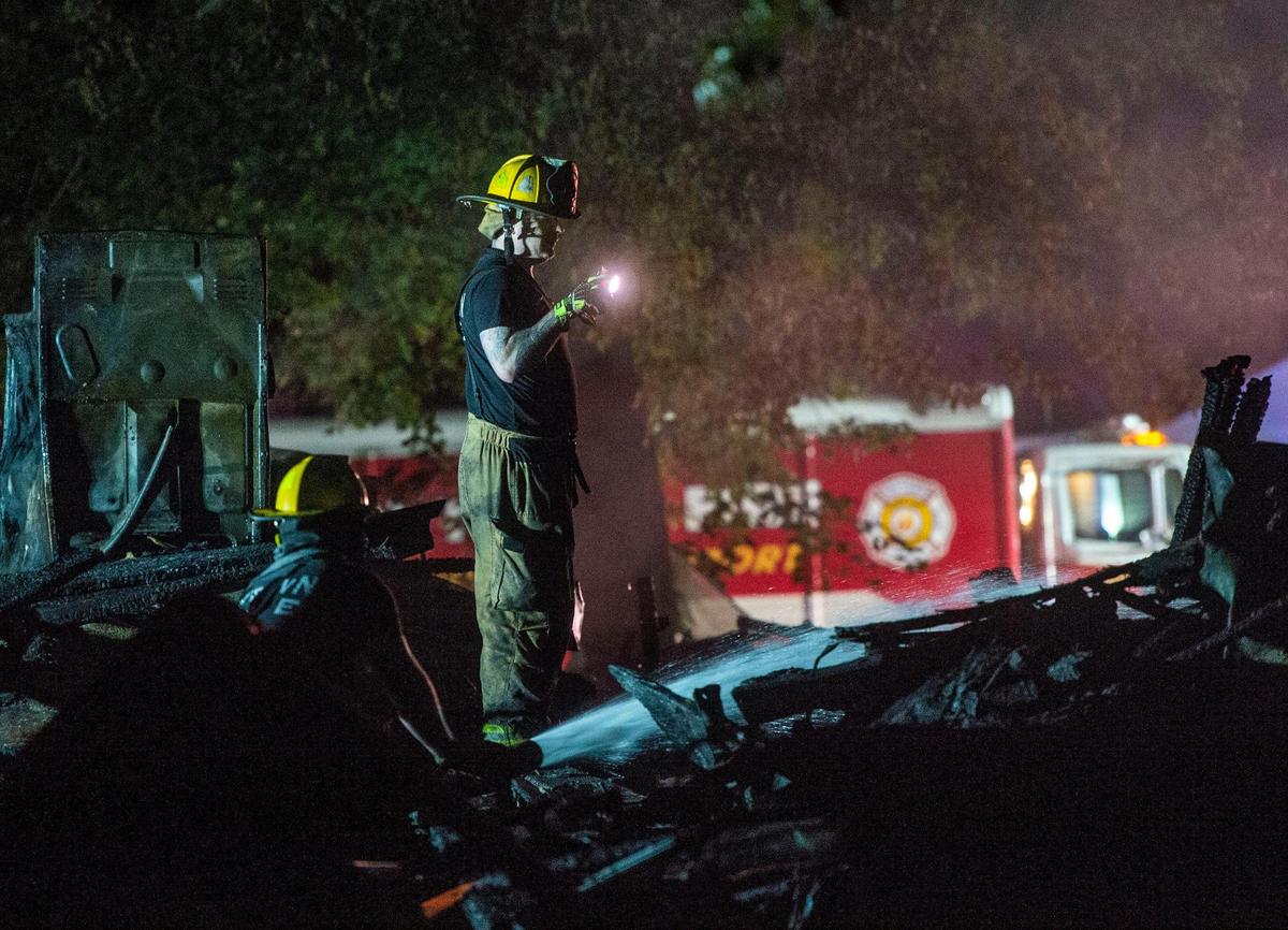 Raytown firefighters and police look over the scene after a duplex exploded in 7500 block of Englewood Avenue, Monday, June 28, 2021 in Raytown, Mo. The cause of the fire is still under investigation