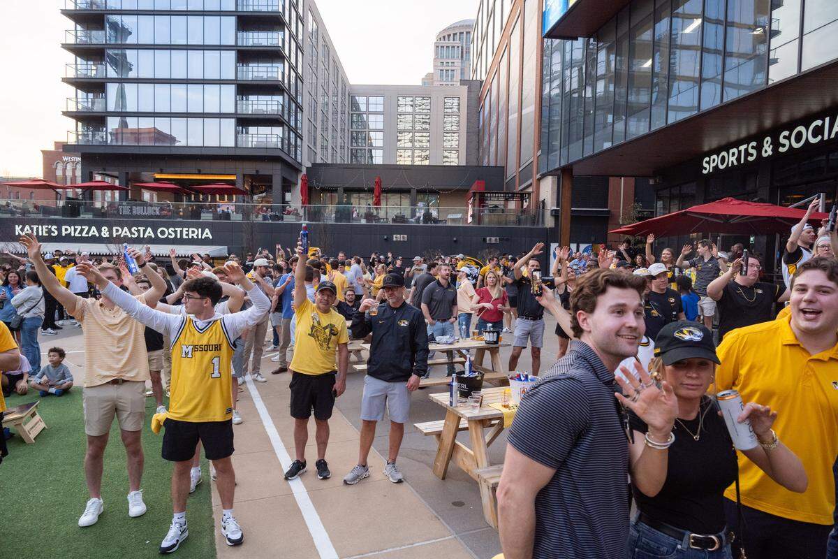 Missouri Tigers fans perform their school chant at the Mizzou Spirit Rally at Ballpark Village on Friday, March 20, 2026, in St. Louis. The Missouri Tigers faced off against the Miami Hurricanes in the first round of the NCAA Men's Basketball Tournament in St. Louis.