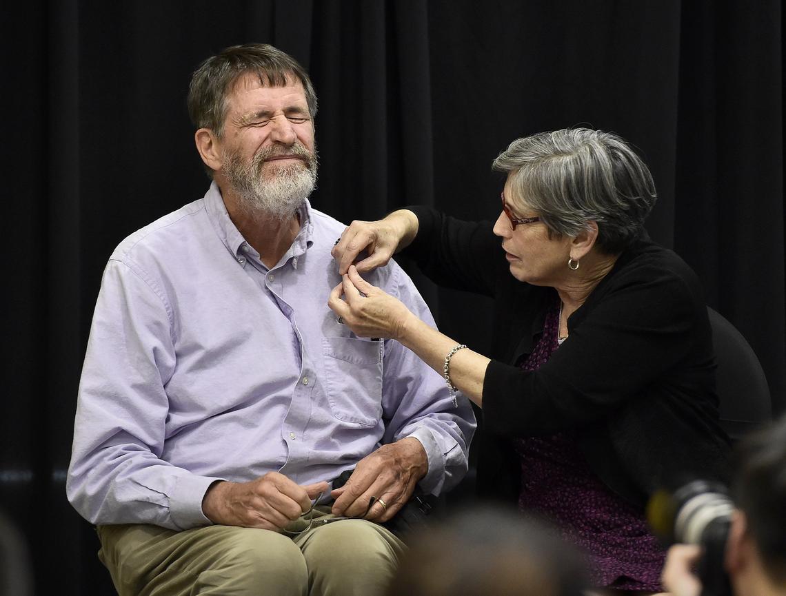 George P. Smith, professor emeritus at the University of Missouri in Columbia, was awarded the Nobel Prize in chemistry for developing a method known as phage display. Before a press conference at Memorial Student Union recognizing the award, Smith pretended to prepare to be stuck by a needle as his wife Marjorie Sable put a MU College of Arts and Sciences pin on him.