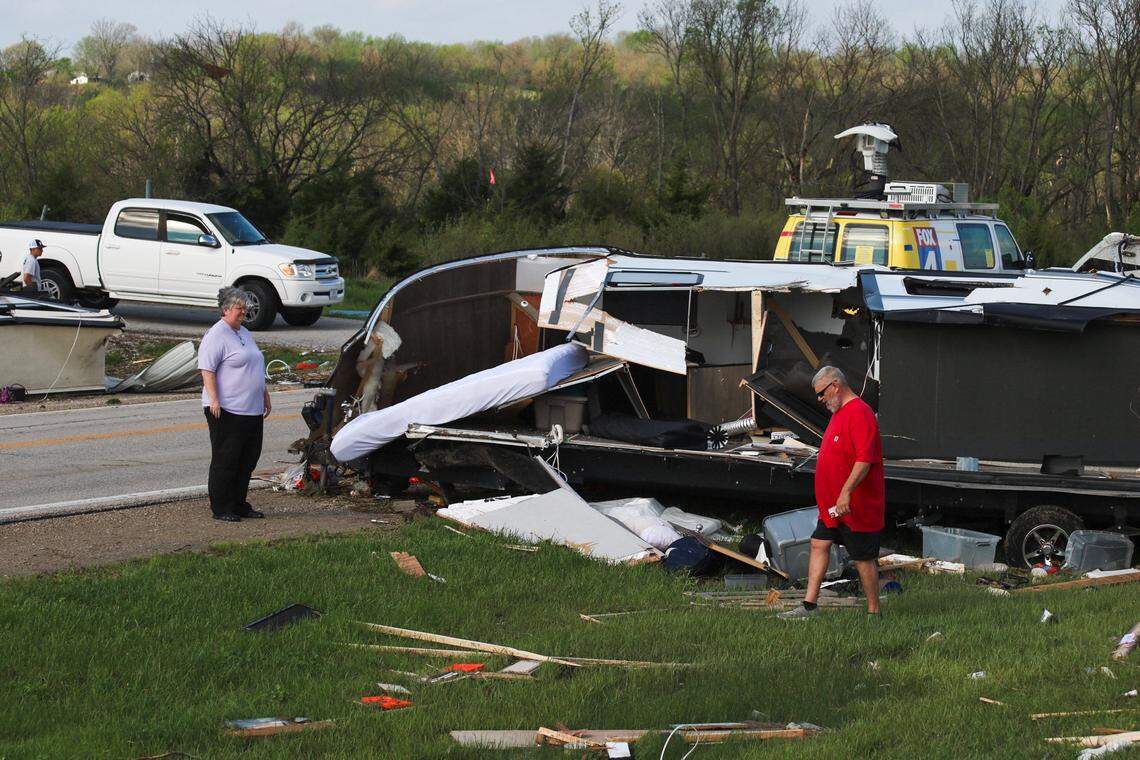People look over items lost in a storm at Hillsdale Boat & Mini Storage on April 14, 2026 after a tornado ripped through the area the night before.