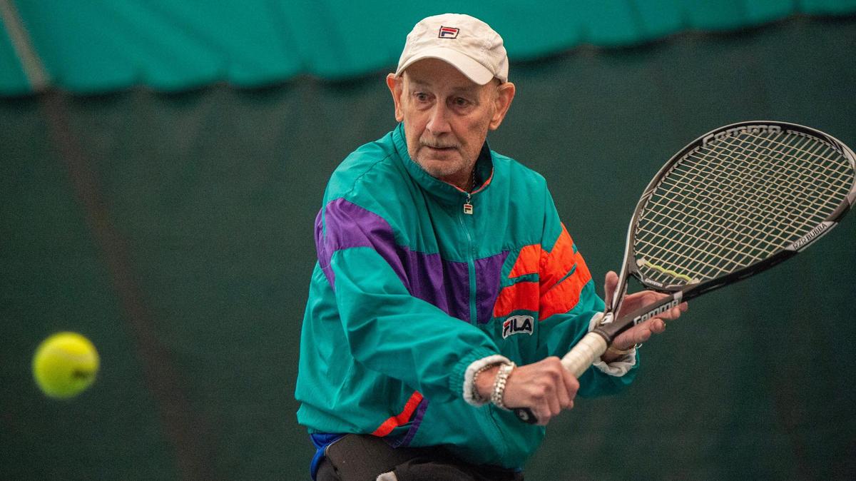 Ray Lake, 79, chases down a ball while warming up at Woodside Health and Tennis Club. 