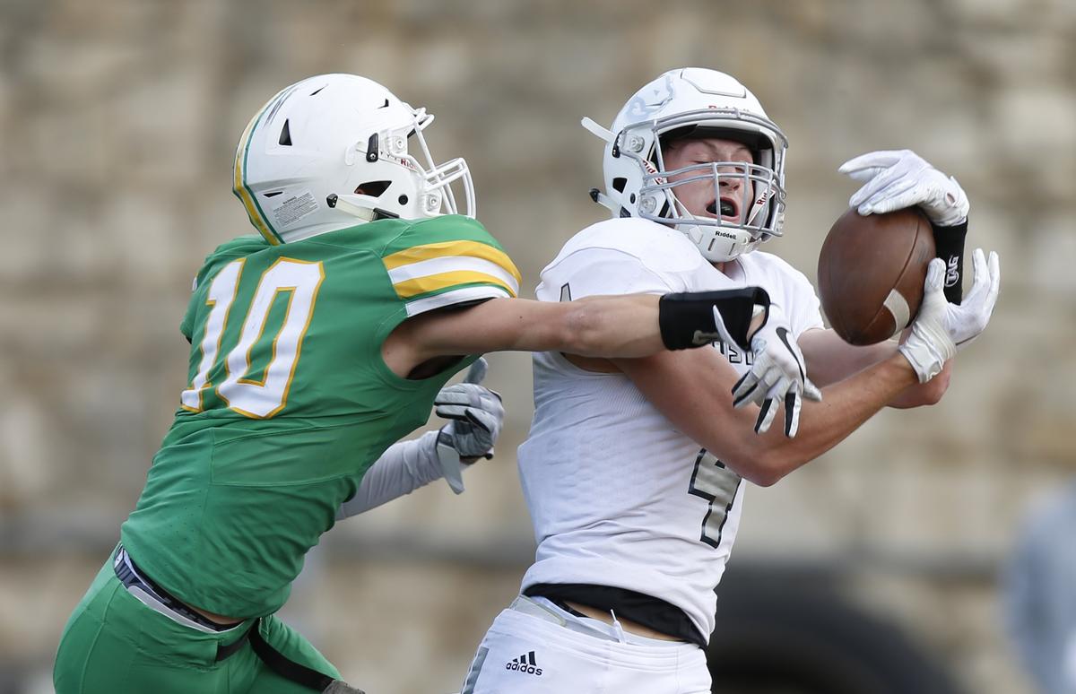 Blue Valley North wide receiver Cameron Burt reels in a touchdown pass for the first the first touchdown of the day. Derby’s #10 Dax Benway was defending on the play.  (November 24, 2018)