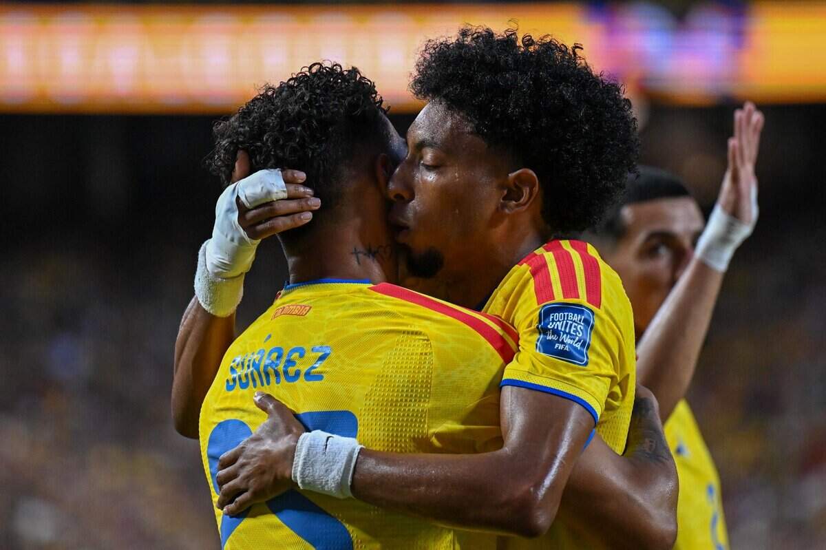 Colombia defender Johan Mojica (17) hugs teammate and forward Luis Suárez (25) after their team’s first goal vs. Ghana in a World Cup Round of 32 football match at Kansas City (Arrowhead) Stadium in Kansas City on Friday, July 3, 2026.