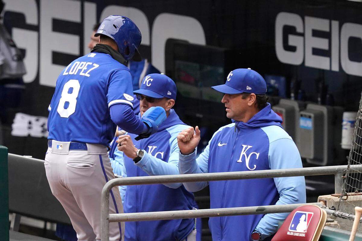 Nicky Lopez (No. 8) is greeted at the dugout by manager Mike Matheny after scoring during Thursday’s win against the White Sox in Chicago.