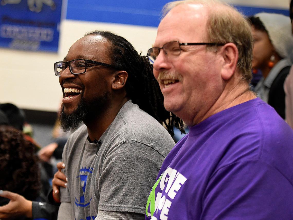 In this February 2019 photo, Christopher Hutson, left, whose son was killed in a road rage incident, watched a basketball game with Gary Dixon, who received Christopher Hutson Jr.’s heart after he died.