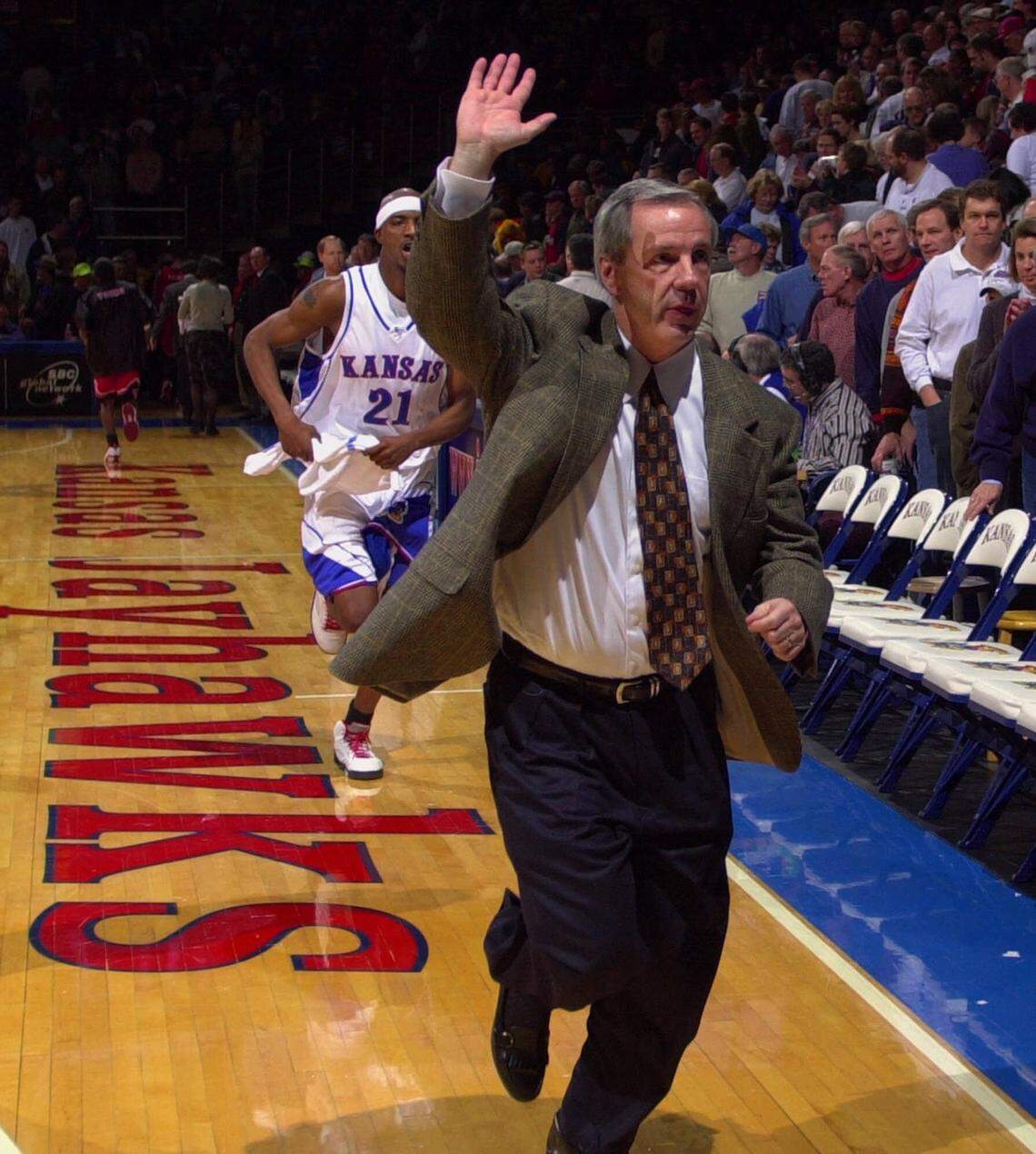 Kansas coach Roy Williams acknowledges the cheers of the crowd as he and the team leave the court after beating Texas Tech 87-62 Saturday, Feb. 5, 2000, at Allen Fieldhouse in Lawrence, Kan. After the game Williams said he appreciated the reception the team got from the home crowd. It was the first home game for Kansas since Jan. 24, when Williams called Jayhawks fans a “wine and cheese crowd” for what he considered a lack of support in an victory over Colorado. Williams apologized a day later for his remarks, and fans Saturday cheered loudly throughout the game.