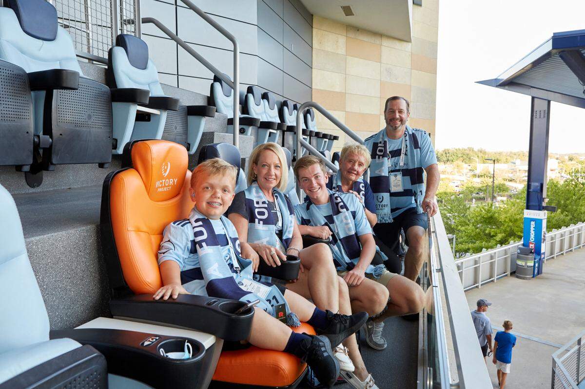 Bryce Pinter, left, is a Kansas City 14-year-old who was born with dwarfism. He is involved with the Variety KC organization and its efforts to increase inclusion around town, and Saturday evening he sat in the Victory Seat for Sporting KC’s game against Colorado at Children’s Mercy Park.