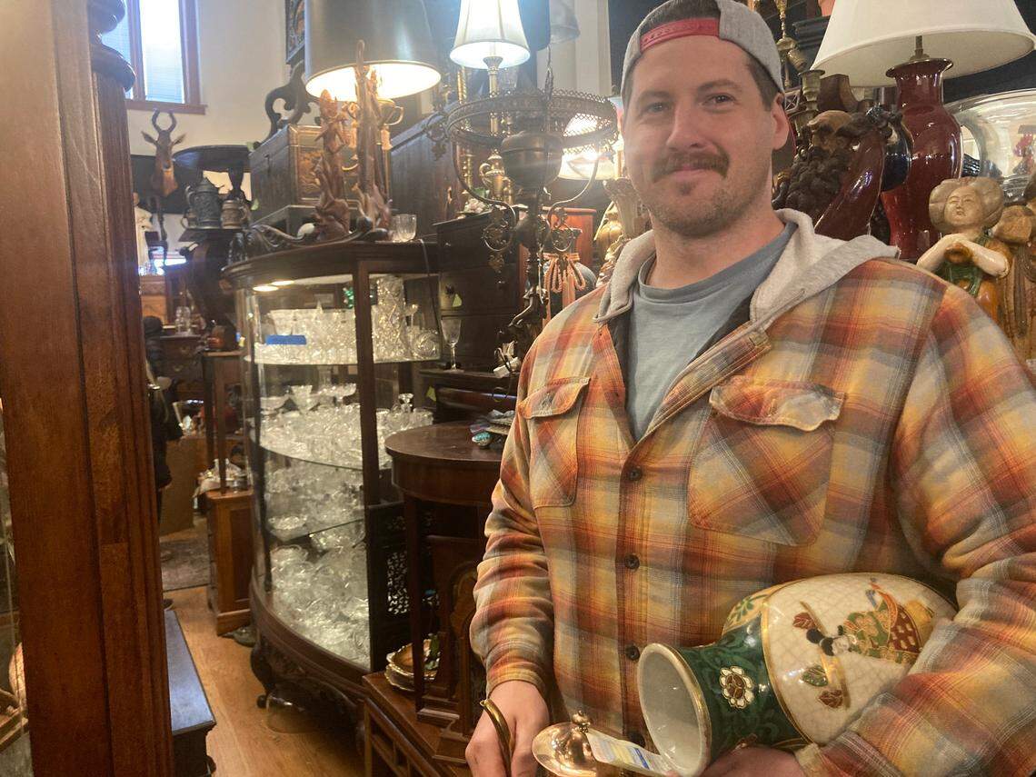 Konner Wales, 33, of Kansas City looking for bargains at the antiques building reopened to the public for two final days at 4501 Genessee St
